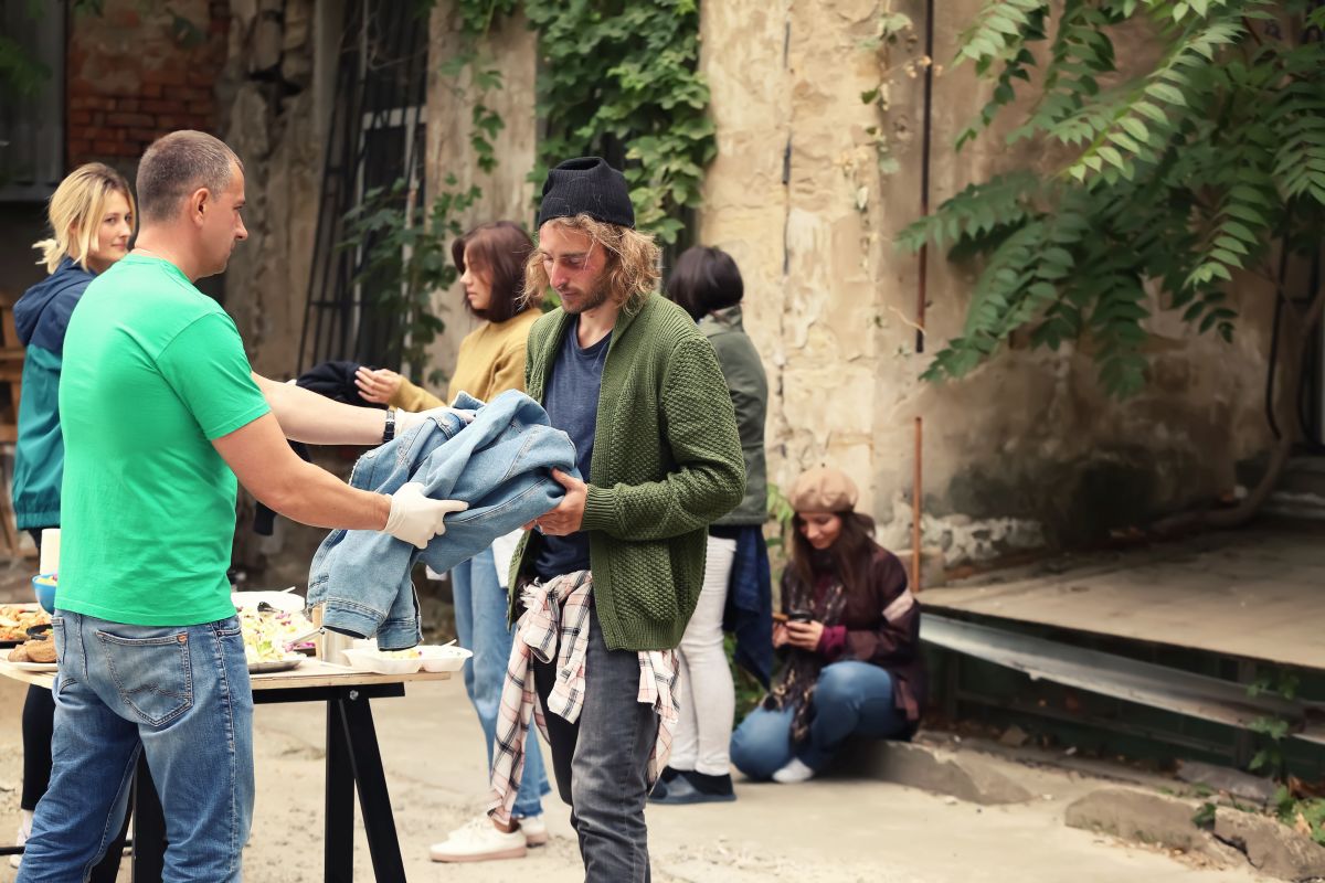 Volunteers giving clothes and Food